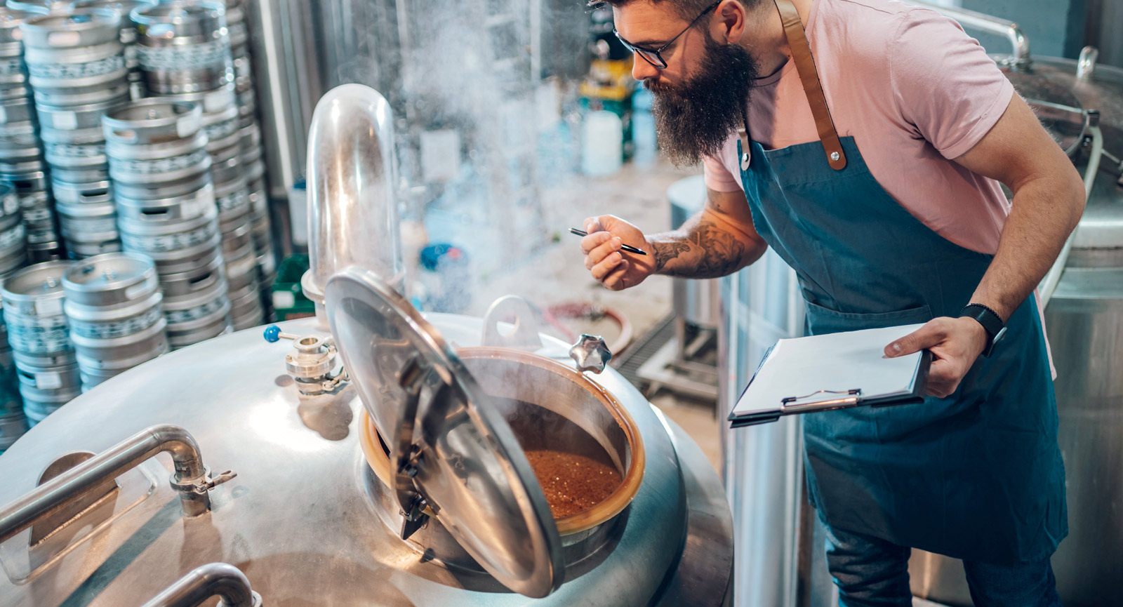 Brewer checking kettle