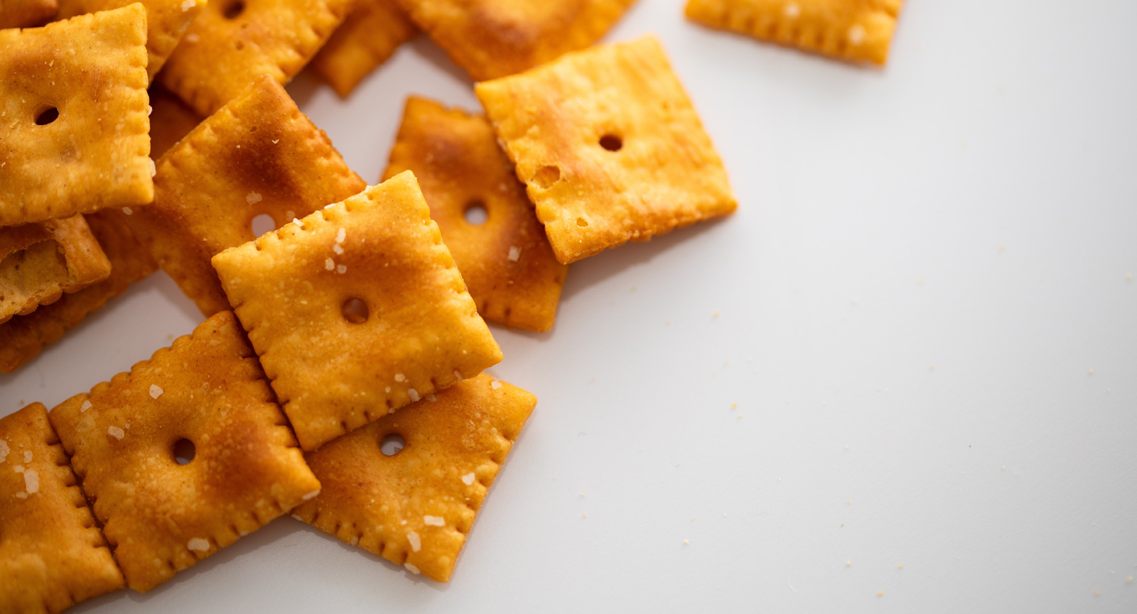 Baked cheese crackers on a white background