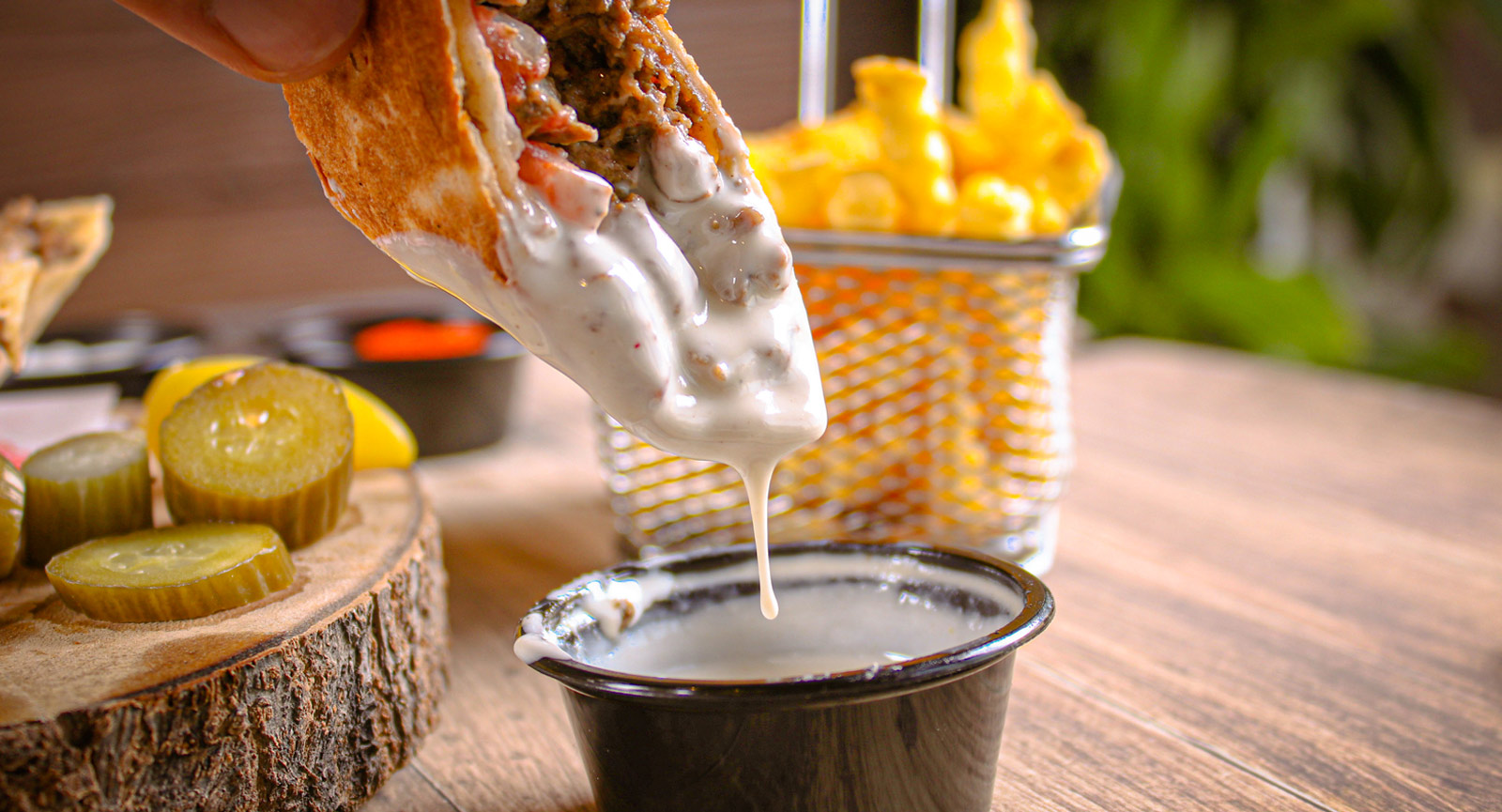 Dipping shawarma with sauce