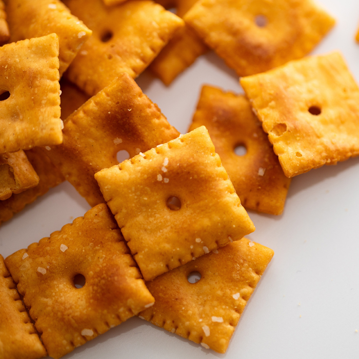 Baked cheese crackers on a white background