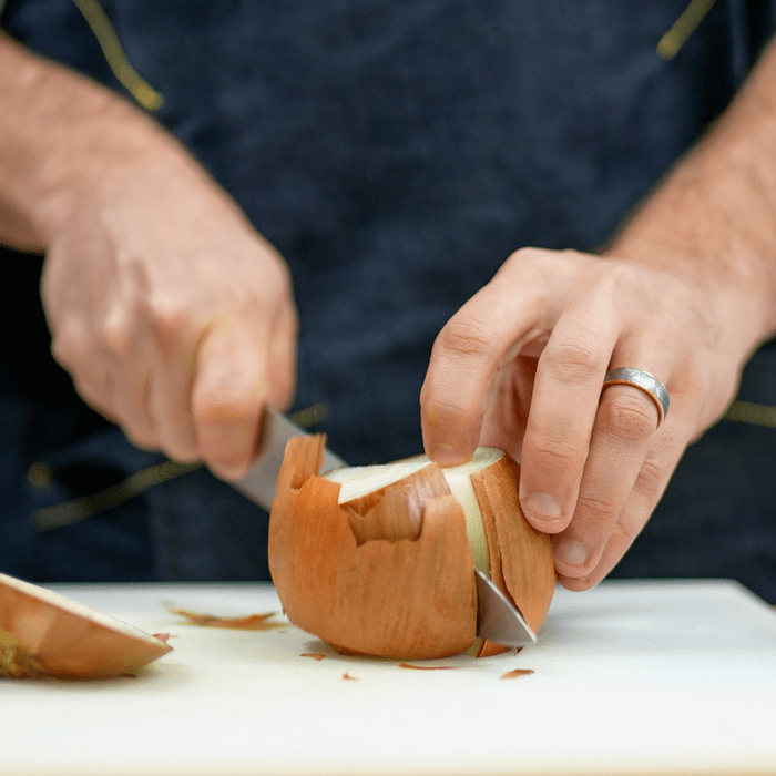 Chef cutting an onion