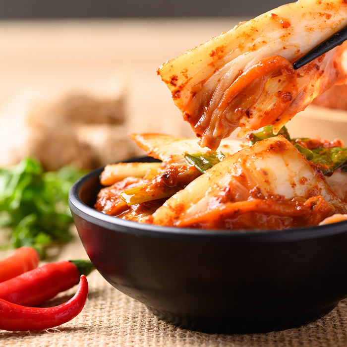 Kimchi being eaten with chopsticks
