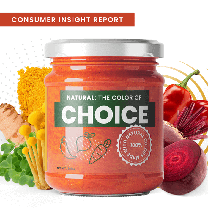 A jar of red sauce in the foreground with ingredients like beets, peppers, and carrots in the background