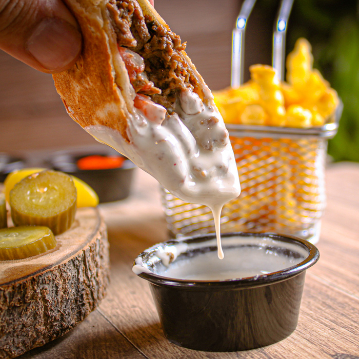 Dipping shawarma with sauce