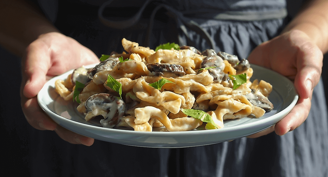 Plate of noodles with mushrooms and cream sauce