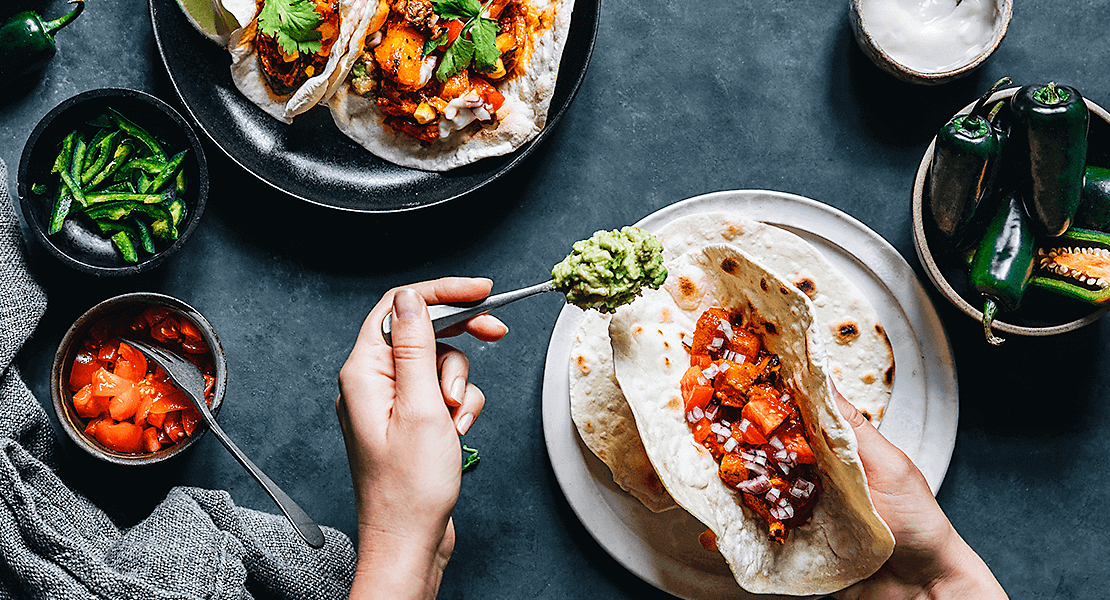 Adding guacamole to a taco