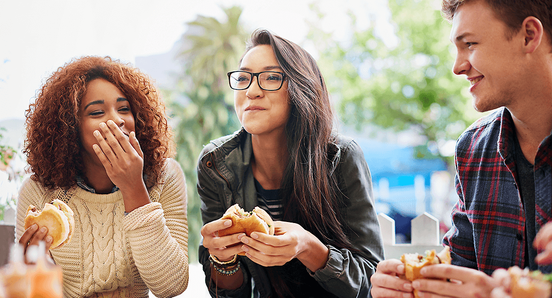 People enjoying eating burgers