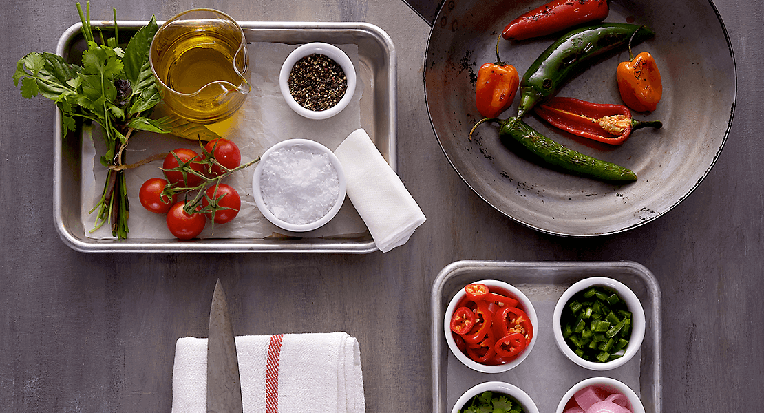 Mise en place of peppers, herbs and seasonings